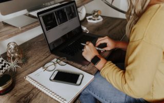 Woman working at your desk at home, with a laptop and phone